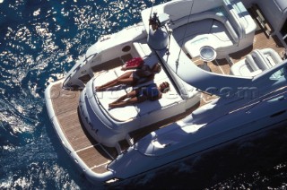 Two women sunbathing on sundeck of Fairline Targa 48