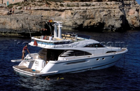 A luxurious Fairline Squadron 58 at rest in a tranquil bay in Majorca