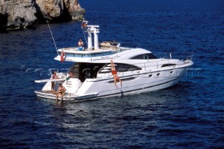 A luxurious Fairline Squadron 58 at rest in a tranquil bay in Majorca