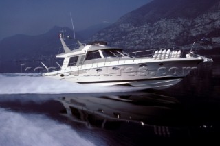 Riva Superaquarama at speed on flat calm sea water in the Mediterranean