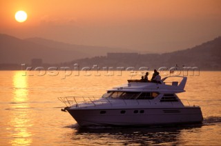 Fairline Corniche in calm bay at sunset