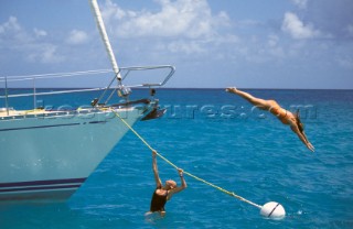 Woman diving off boat into water