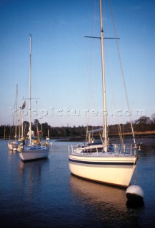 Boats moored on a still river in early morning