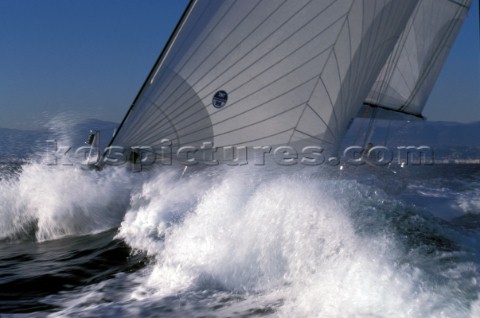 Bow of maxi yacht with North Sails logo in crashing wave