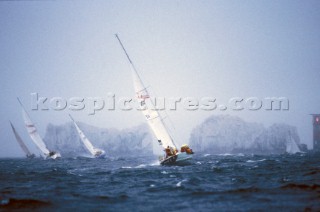 Yachts racing towards The Needles off the Isle of Wight, in stormy conditions