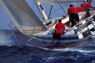 Crew to leeward trimming the 3DL jib onboard the Swan 60 Highland Fling racing upwind