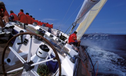 Crew to leeward trimming the 3DL jib onboard the Swan 60 Highland Fling racing upwind