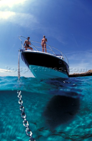 Male and female models relaxing and socialising on a luxury Fairline powerboat