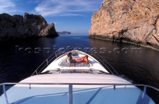 Male and female models relaxing and socialising on a luxury Fairline powerboat