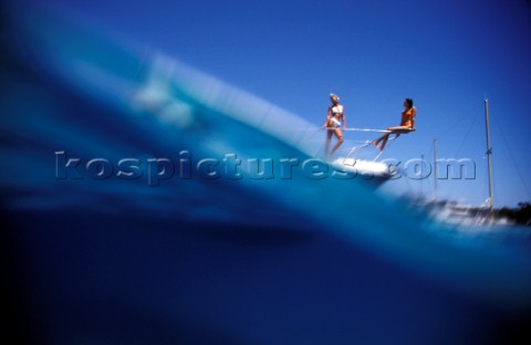 Male and female models relaxing and socialising on a luxury Fairline powerboat