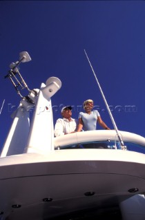 Male and female models relaxing and socialising on a luxury Fairline powerboat