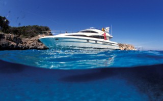 Male and female models relaxing and socialising on a luxury Fairline powerboat