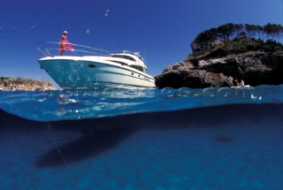 Male and female models relaxing and socialising on a luxury Fairline powerboat