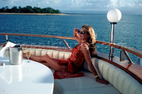 Woman relaxing on deck of superyacht