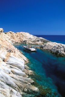 Wally tender powerboat at anchor in an idyllic secluded bay amongst rocks