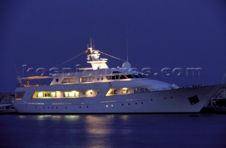 Cruising superyacht Idyll at anchor at night in a quiet anchorage mooring