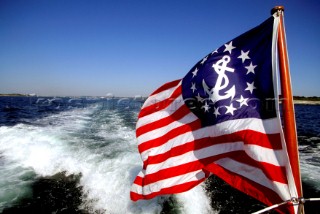 Stars and Stripes flag with anchor on stern of power boat