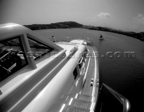 Black and white of a cruising superyacht at anchor in a quiet anchorage mooring