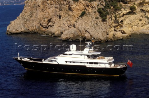 Cruising superyacht at anchor in a quiet anchorage mooring