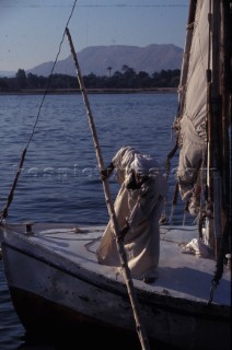 Egypt - The Nile at Luxor Man pushes off on Felucca