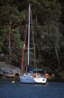 Cruising yacht at anchor in a secluded bay