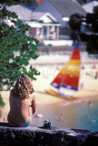 Topless girl with Hobie cat on beach