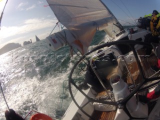 Helmsman driving upwind in rough seas onboard the Norwegian J133 Madjus during the JP Morgan Round the Island Race 2012 by The Needles