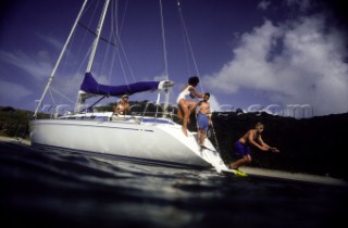 Two women and two children on a sailboat.