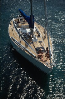 Couple lying on a sailboat at anchor