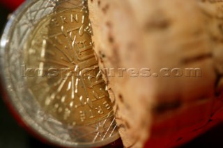 Champagne cork with coin on wet weather oil skins for good luck