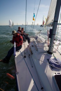 Male navigator using GPS to sail in a yacht race Round the Island Race on a J80 sportsboat