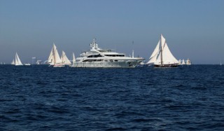 Superyacht with sailing yachts in St Tropez