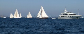 Superyacht with sailing yachts in St Tropez