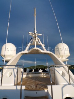 Superyacht in the Mediterranean. Navigation mast with Furnuo radar and communication aerials and satcom dishes