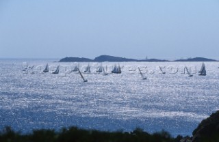 Fleet of Swan yachts racing through the Maddalena Islands off Port Cervo Sardinia during the Rolex Swan World Cup