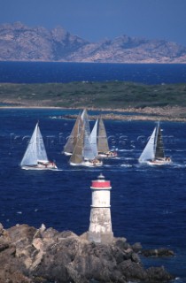 Fleet of Swan yachts racing through the Maddalena Islands off Port Cervo Sardinia during the Rolex Swan World Cup