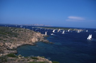 Fleet of Swan yachts racing through the Maddalena Islands off Port Cervo Sardinia during the Rolex Swan World Cup