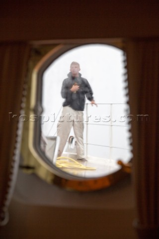 Crew seen through a porthole onboard superyacht Talitha
