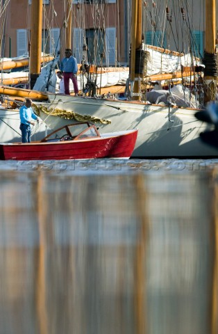 SAINTTROPEZ FRANCE   OCT 5th As the classic yachts prepare to leave port the harbour launch helps th