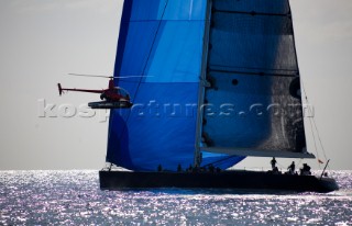 SAINT-TROPEZ, FRANCE - A press helicopter hovers close to the Wally maxi yacht Magic Carpet 3 owned by Sir Lyndsey Owen Jones, CEO of LOreal cosmetics, racing in the Voiles de Saint Tropez on October 5th 2006. The largest classic and modern yachts from around the world gather in Saint-Tropez annually for a week of racing and festivities to mark the end of the Mediterranean season, before heading across the Atlantic to winter in the Caribbean.