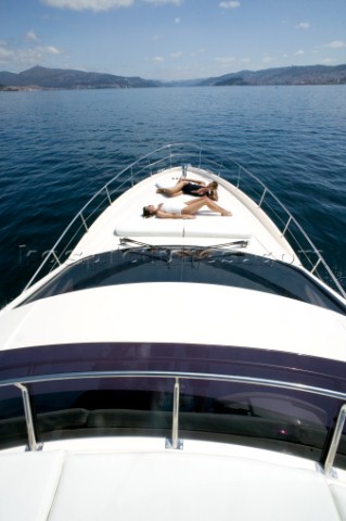 Two women sunbathing on powerboat