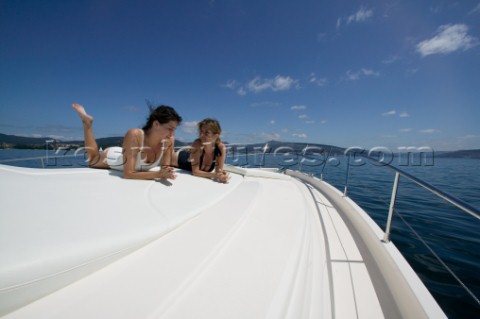 Two women sunbathing on powerboat