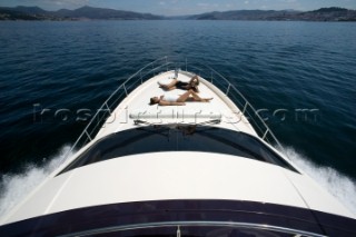 Two women sunbathing on powerboat