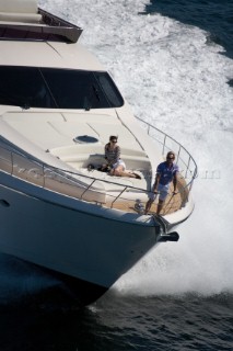 Couple sitting at the front of a powerboat.