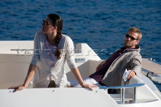 Couple sitting on aft of  a power boat.