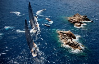 Porto Cervo, Italy. 10/06/2011  LORO PIANA SUPERYACHT REGATTA 2011  Fleet rounds the rocks as the spectator fleet of motorboats scatters