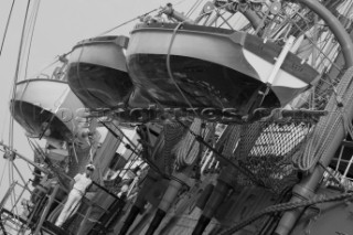 The Tall Ships Races 2007 Mediterranea in Genova. Amerigo Vespucci (Italia). Lifeboats and launches in black and white with sailor on watch.