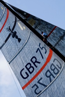 Team Origins GBR-75 makes its maiden voyage from Port Americas Cup in Valencia in company with the yacht America.