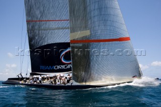 Team Origins GBR-75 makes its maiden voyage from Port Americas Cup in Valencia in company with the yacht America.