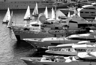 Superyachts moored in Monaco harbour port with yachts sailing